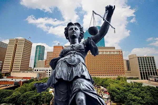 Lady Liberty statue with Fort Worth in the background where The McLarty Law Firm services Criminal Defense with Criminal Defense Attorney Chelsi McLarty on your case.
